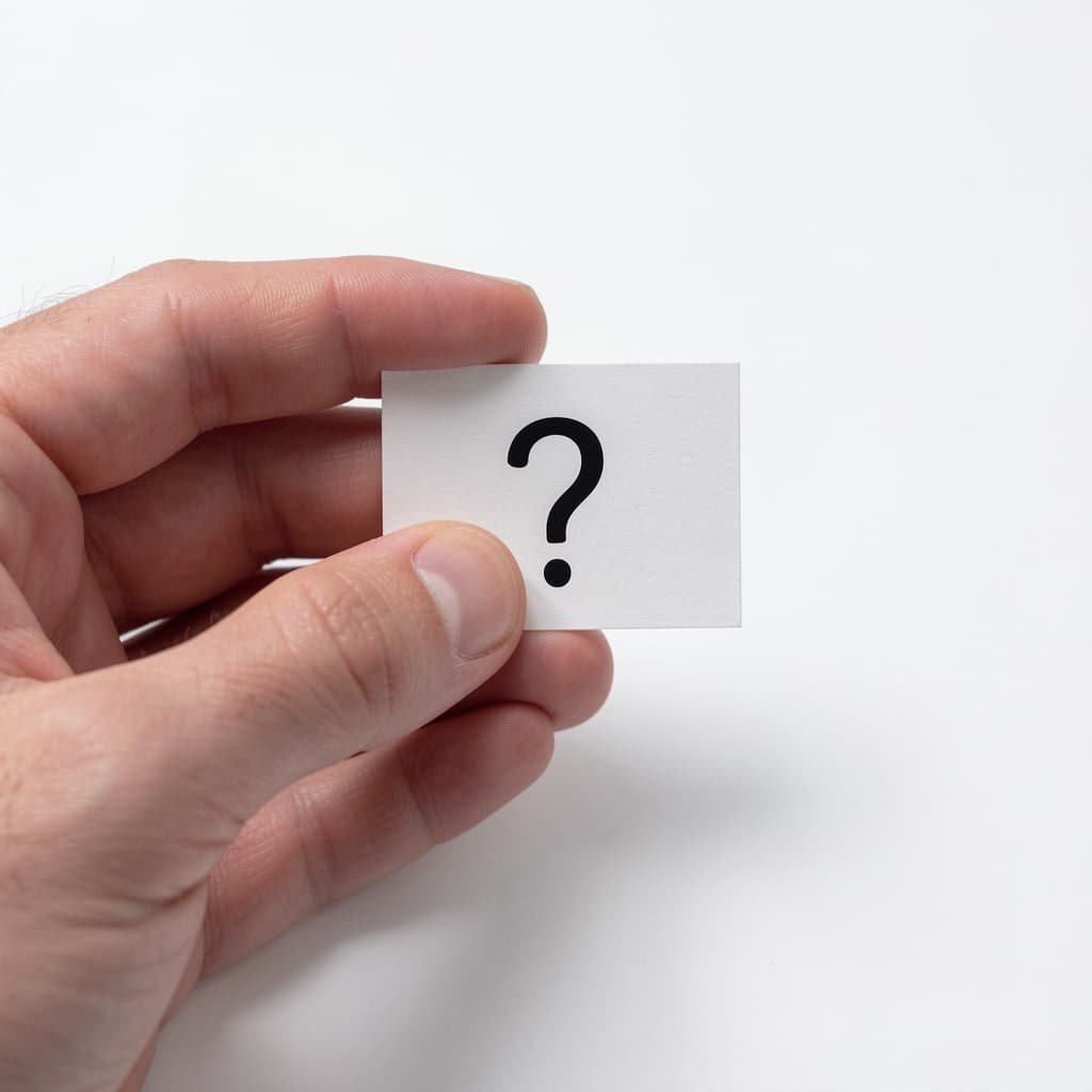 Hand holding a card with a question mark symbol representing frequently asked questions about P shot London treatment and timeline