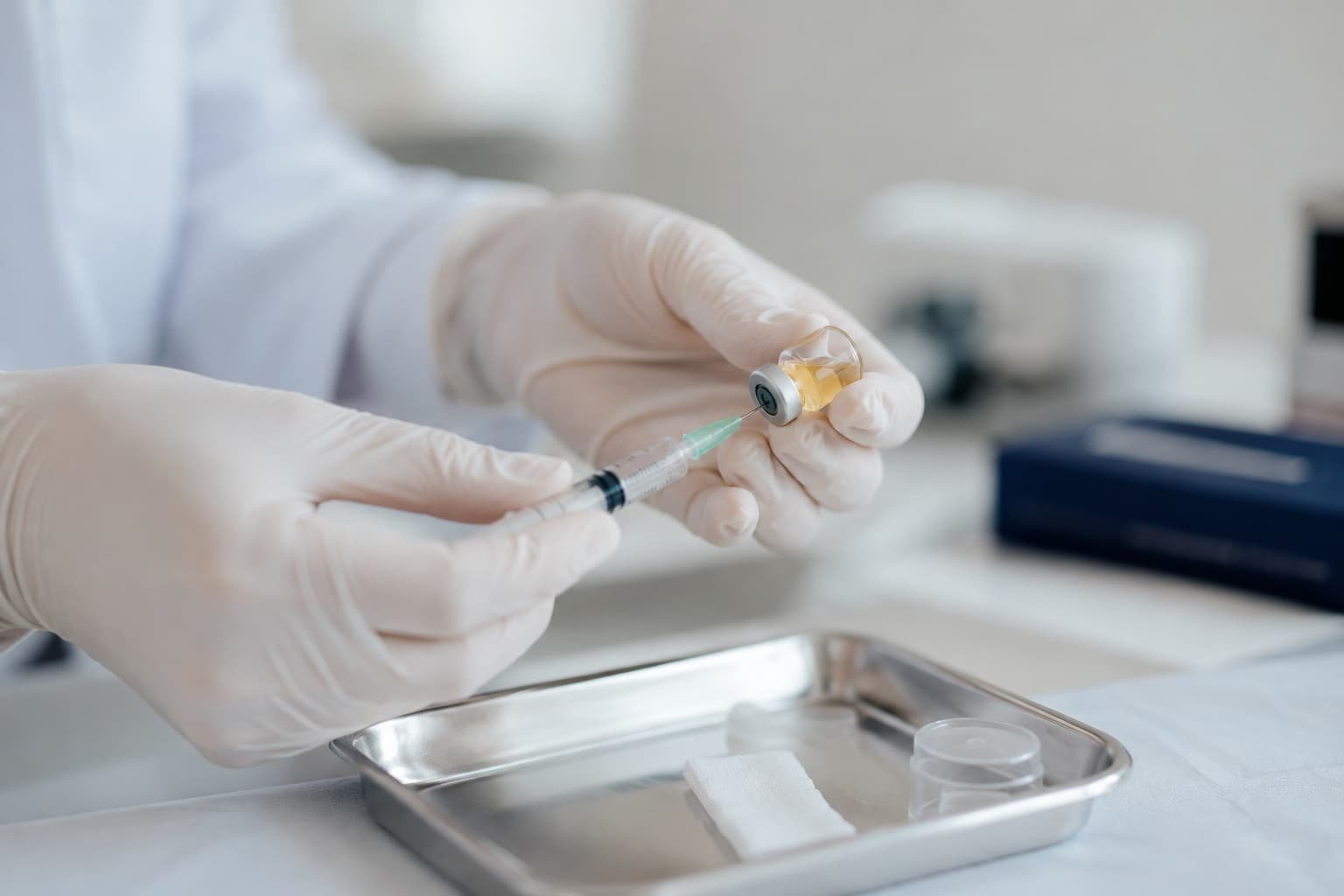 Clinician preparing an injectable treatment in a sterile private clinic setting.